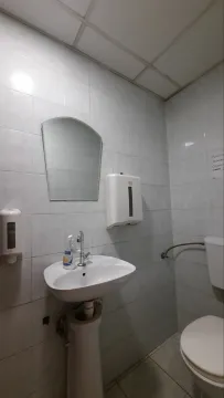 A simple bathroom with a sink and a mirror. - image 5