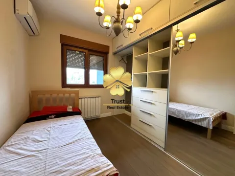 Furnished bedroom with a bed and a large wardrobe. - image 8
