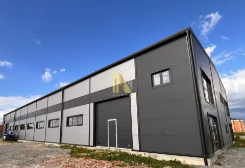 Exterior view of a modern industrial hall or warehouse. - image 4