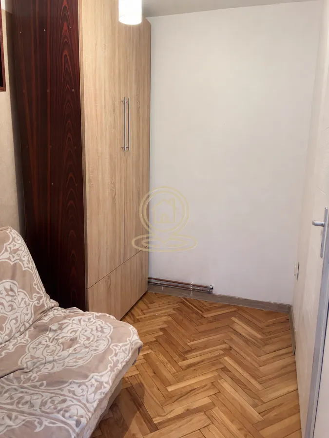 Manja spavaća soba sa ormarom i krevetom na razvlačenje.
