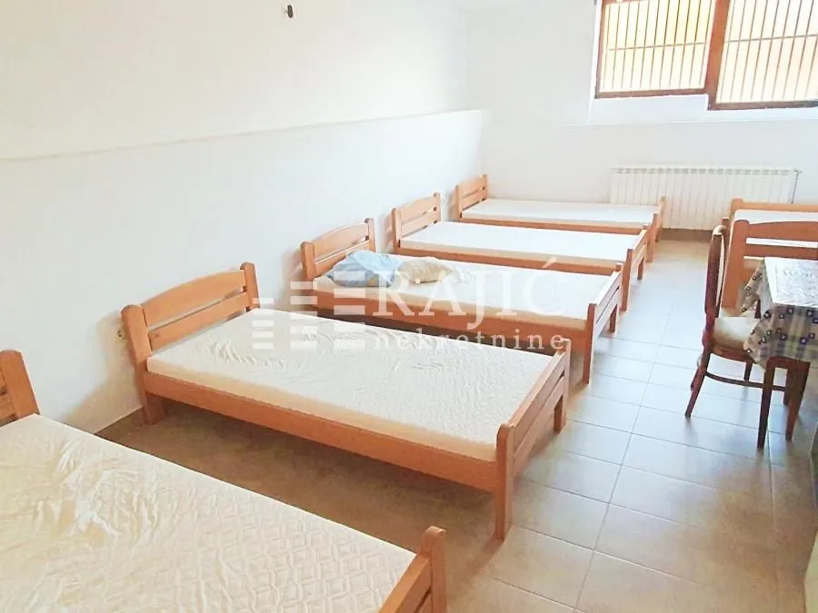 Bedroom with multiple wooden beds.