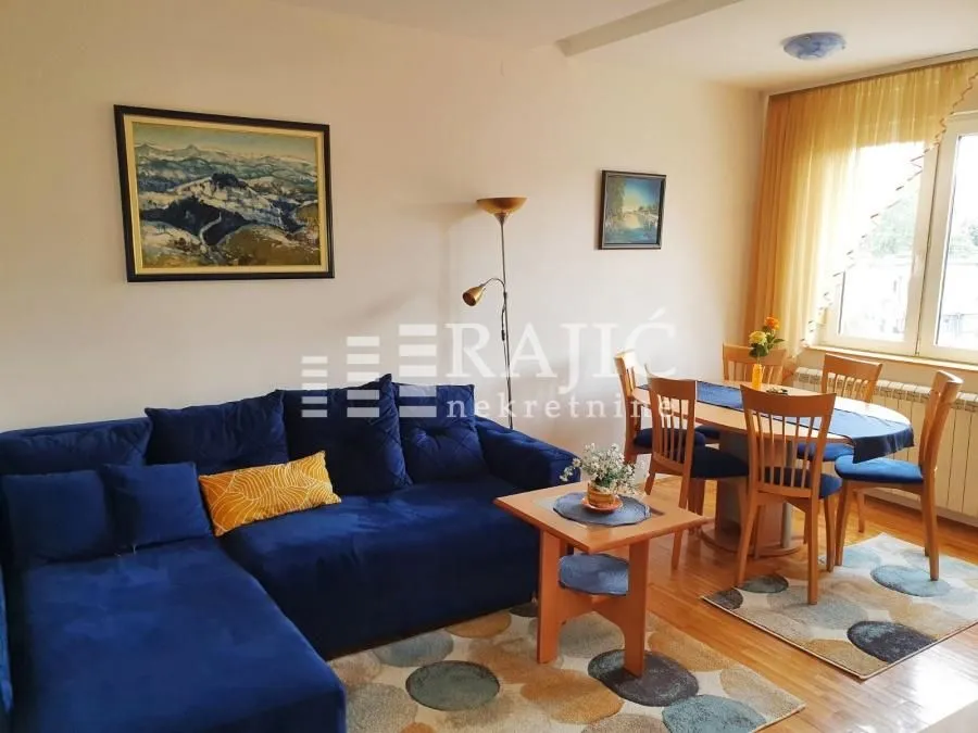 Living room with sofa set and dining area.