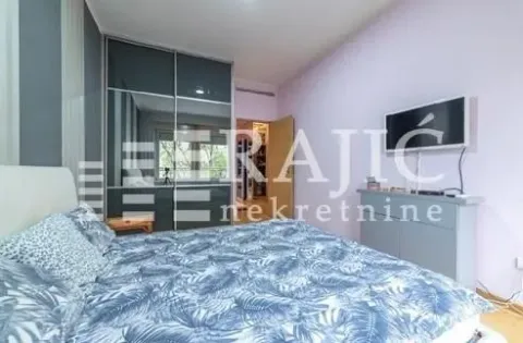 Furnished bedroom with a large double bed, wardrobe, and television. - image 14