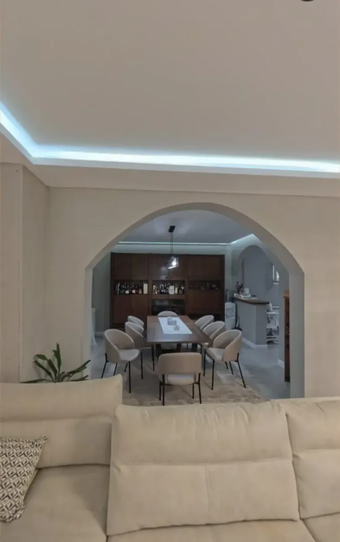 Living room overlooking the dining area and kitchen through an archway.