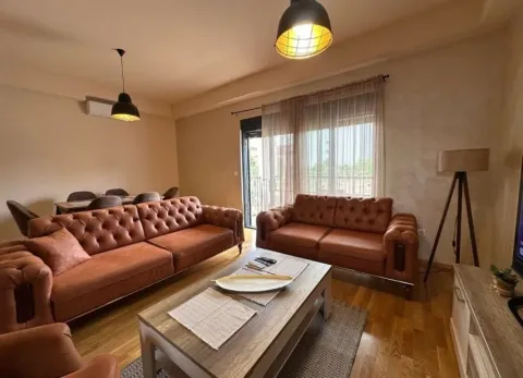 Spacious living room with leather sofas, wooden coffee table and a dining area in the background. - image 12