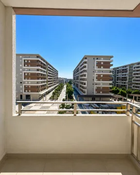 View from the balcony overlooking surrounding residential buildings and courtyard. - image 13