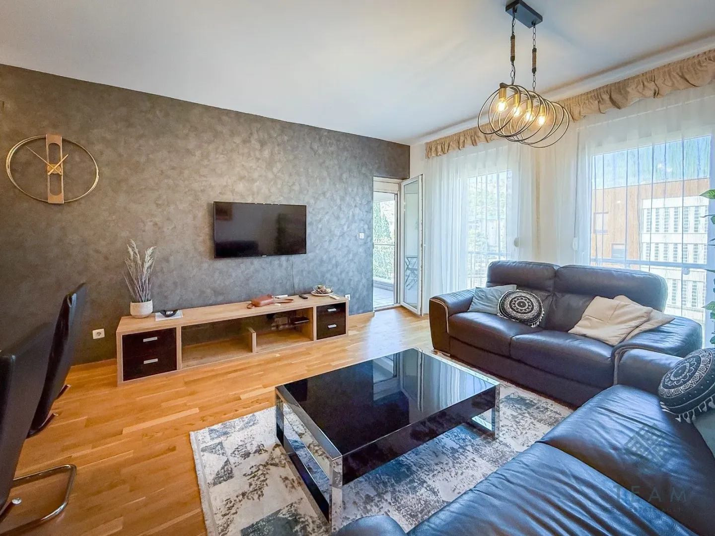 Living room with a sofa, TV, and access to the terrace.