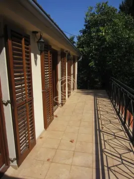 Spacious terrace with tiled floor and wooden shutters on windows and doors. - image 9
