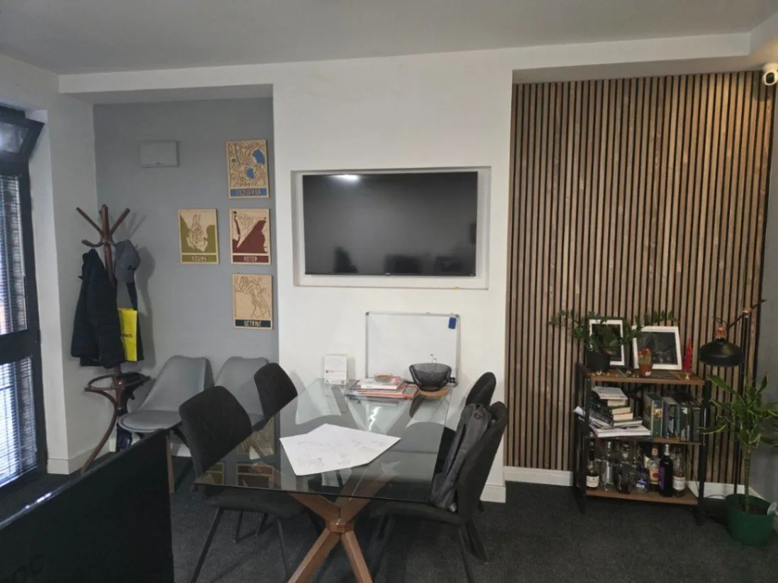 Living room with dining table and TV.