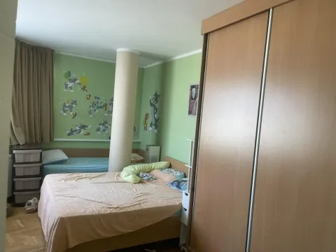 Bedroom with a bed, wardrobe, and green walls featuring cartoon motifs. - image 10