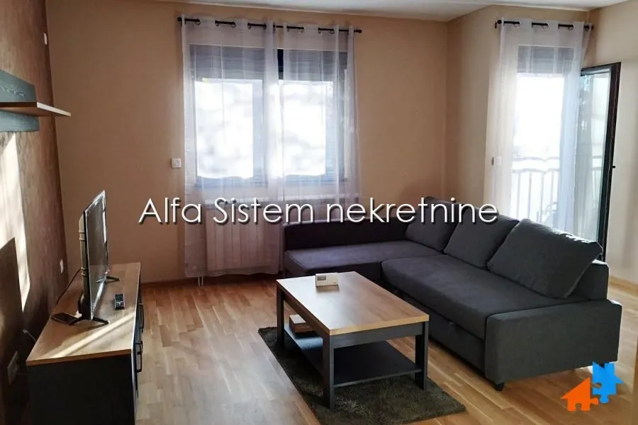 Living room with a sectional sofa, coffee table and TV.