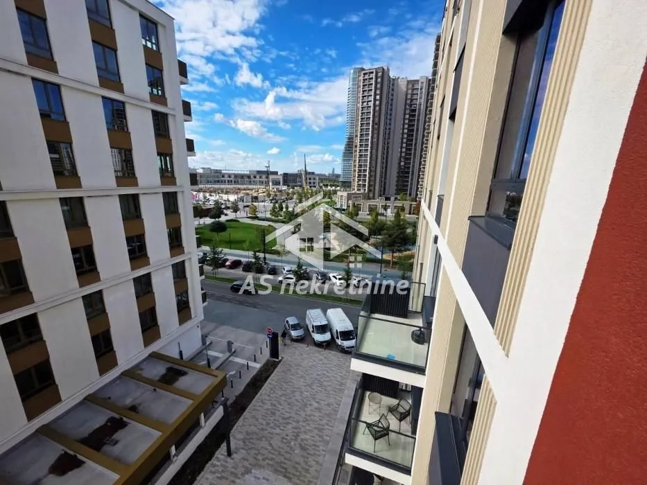 View from the terrace towards the neighborhood and surrounding buildings with a park.