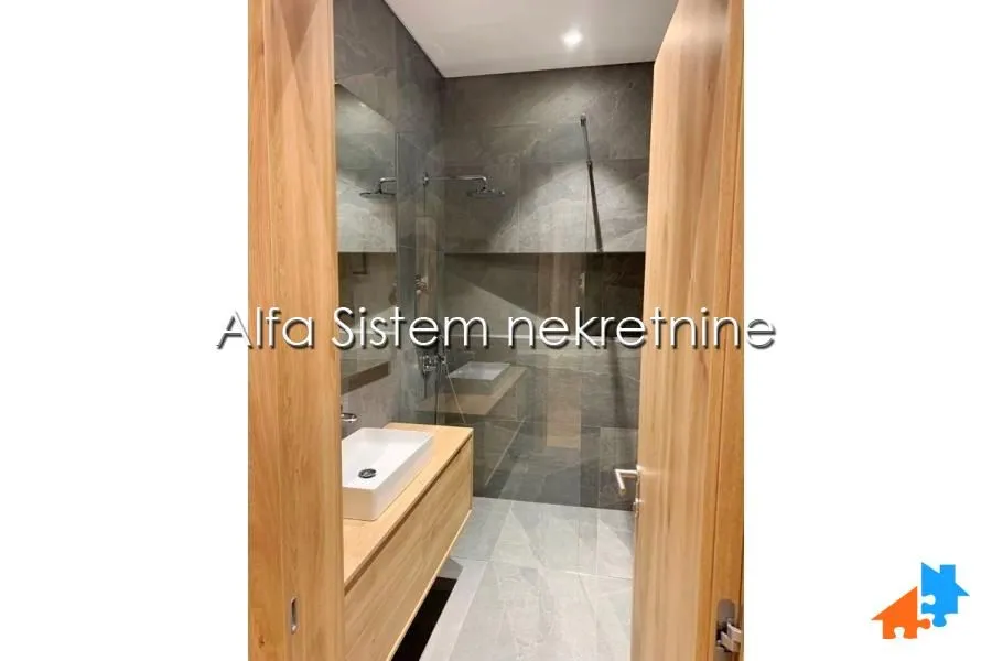 Modern bathroom with a walk-in shower and vanity.