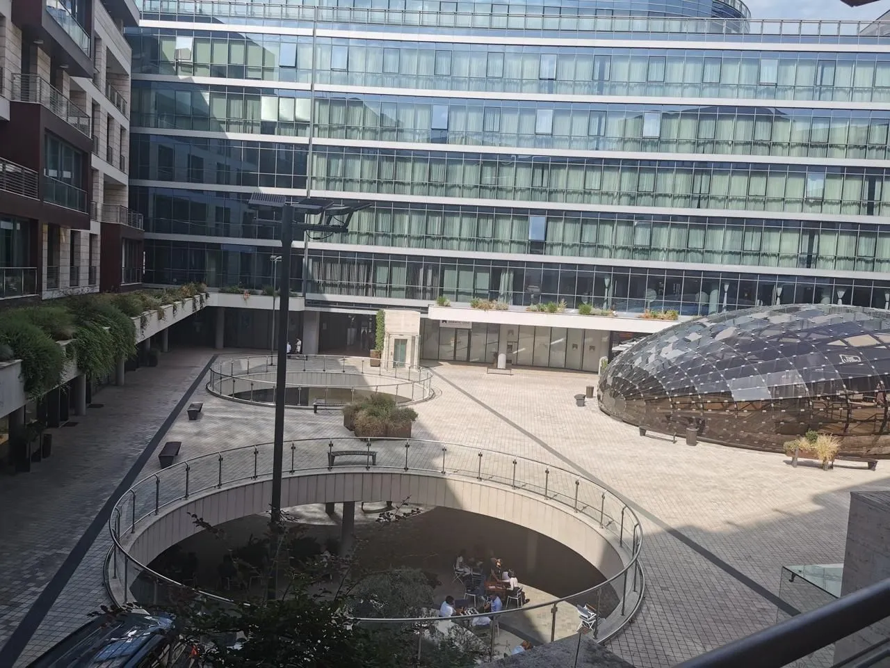 View of a modern courtyard within a residential and commercial complex.