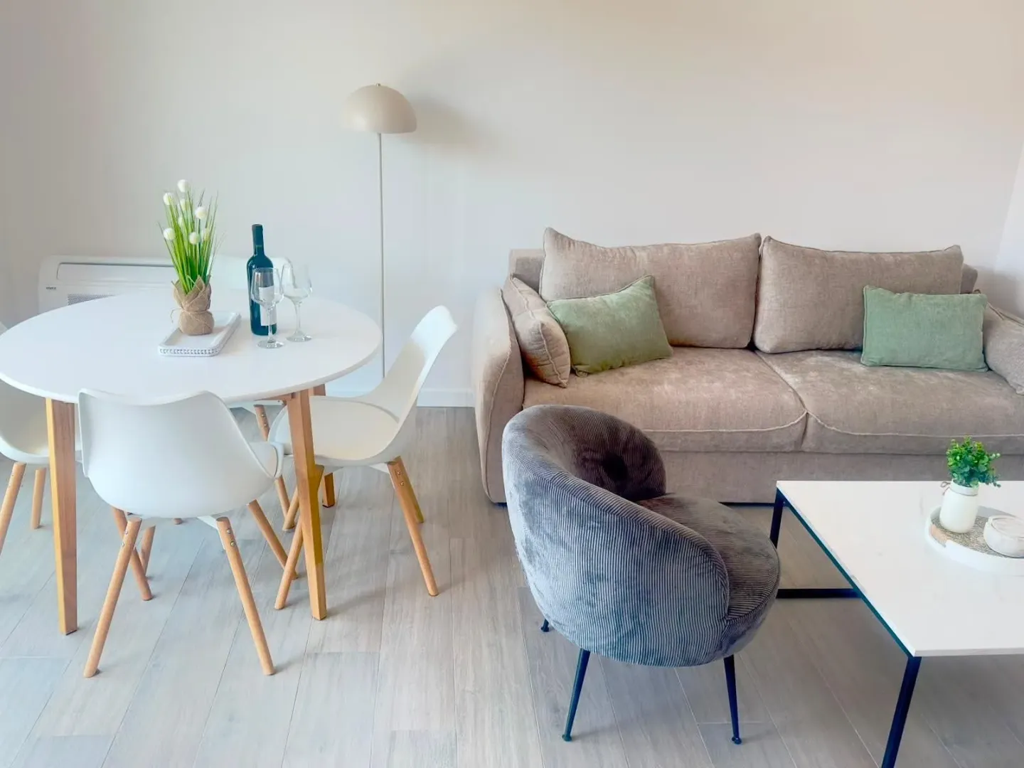Bright living room with a sofa and dining table.