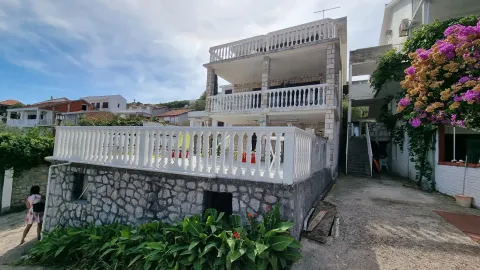 Spoljašnji pogled na višekatnu kuću sa terasama i dvorištem. - image 3