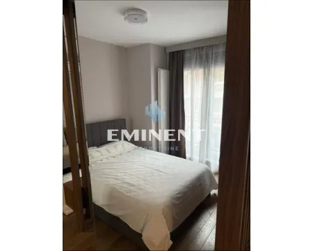 Master bedroom with a double bed and a window with curtains. - image 9