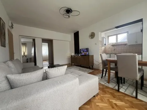 Living room with a sofa, TV, and a dining table in the extension. - image 2