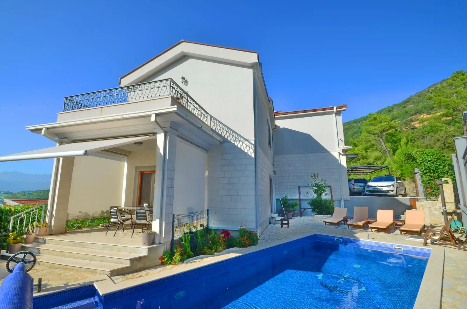Exterior of the house with a swimming pool and terrace.