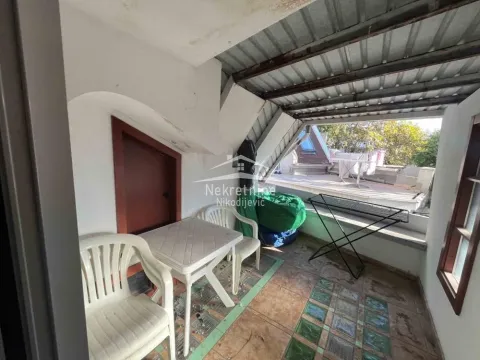Covered terrace with a table, chairs, and access to the open part of the terrace. - image 18