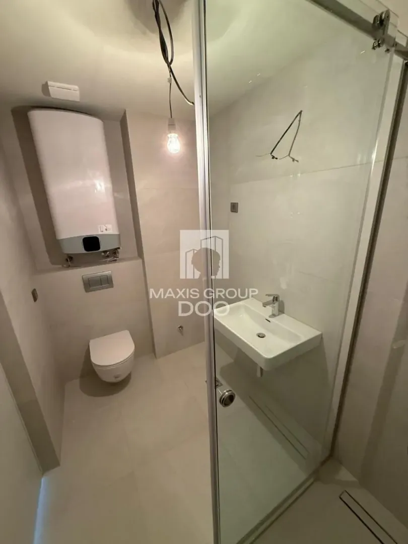 Newly equipped bathroom with sanitaryware and a shower cabin.