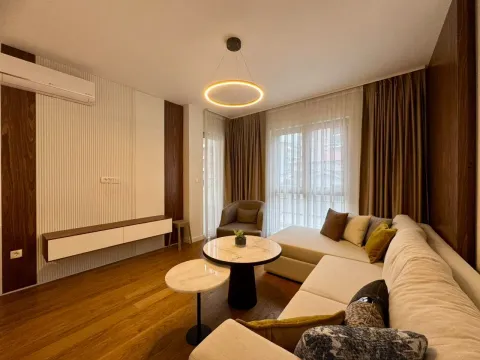 Modern and tidy living room with a sofa, coffee tables, and lighting. - image 13