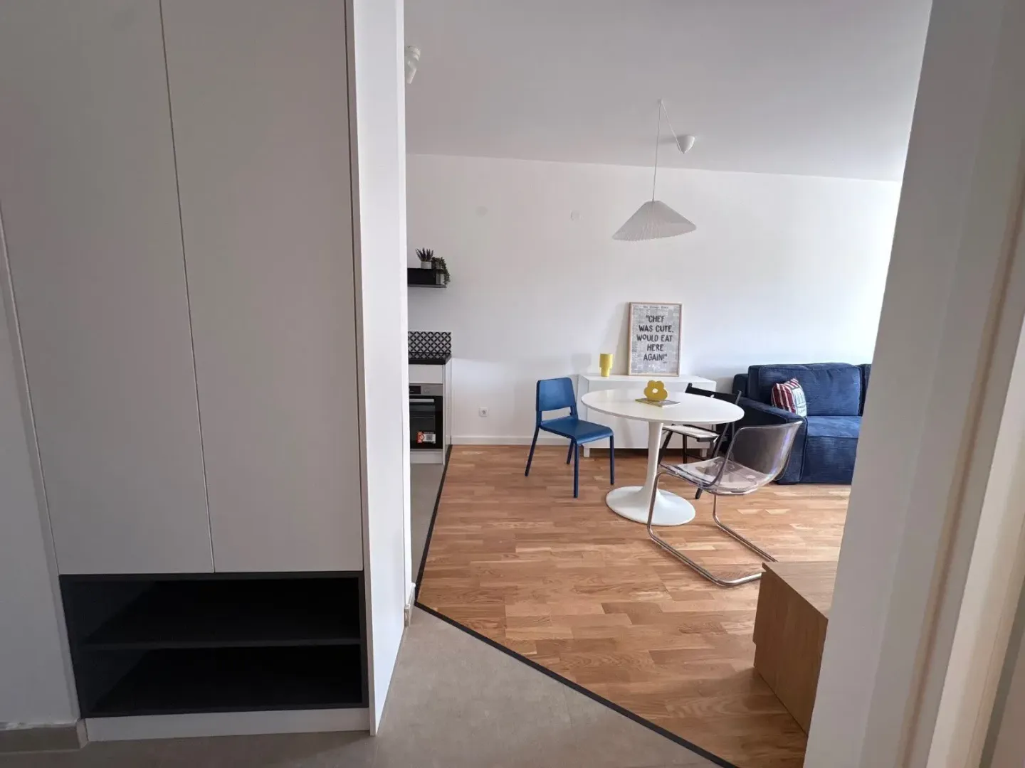 Living room with dining area and kitchen in the background.