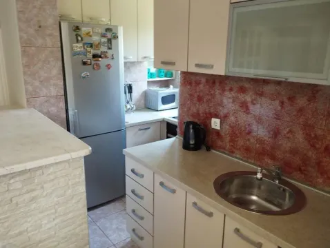 Kitchen with a sink, countertops, refrigerator, and kitchen cabinets. - image 17