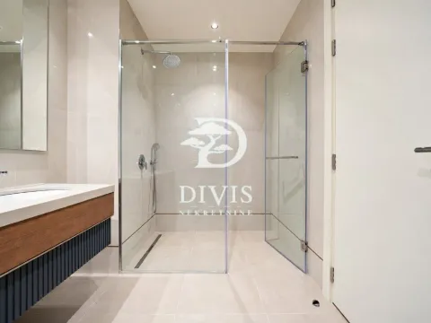 Modern bathroom with a walk-in shower and vanity. - image 19