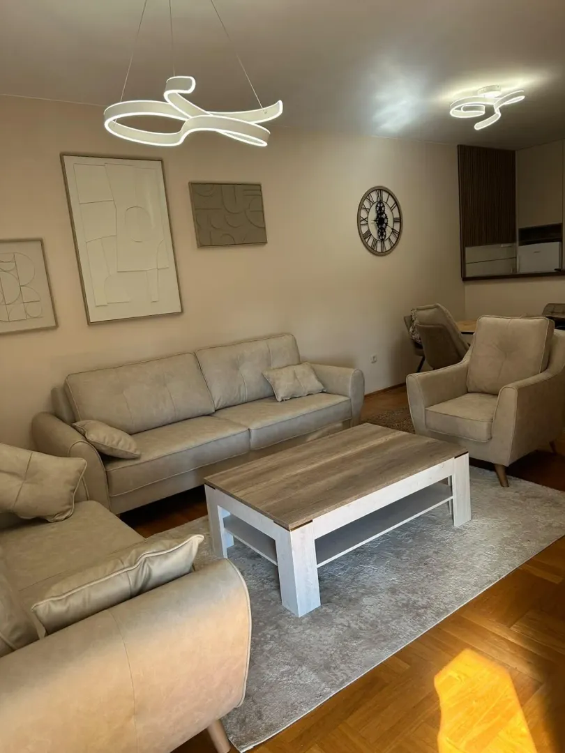 Spacious living room with seating set and dining area.