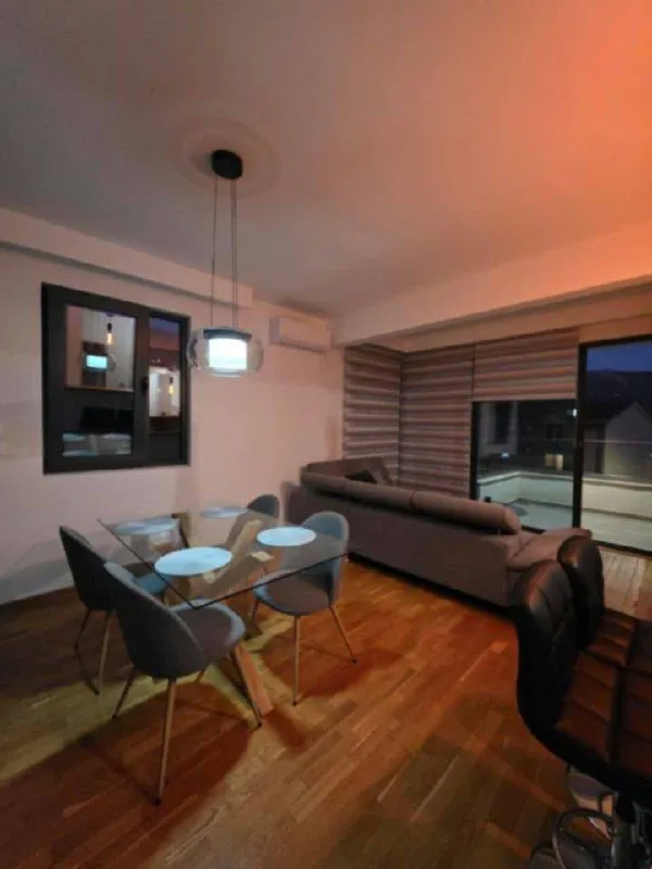 Living room with dining area and sofa.