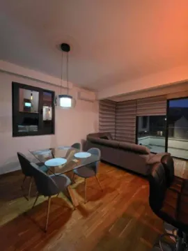 Living room with dining area and sofa. - image 2
