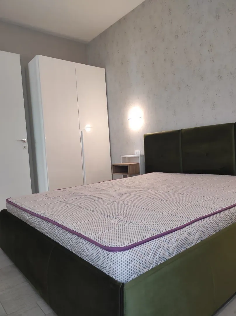 Furnished bedroom with a double bed and wardrobe.