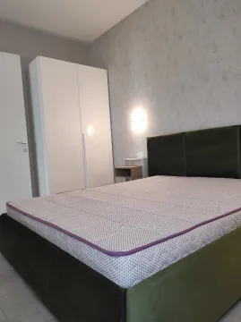Furnished bedroom with a double bed and wardrobe. - image 4