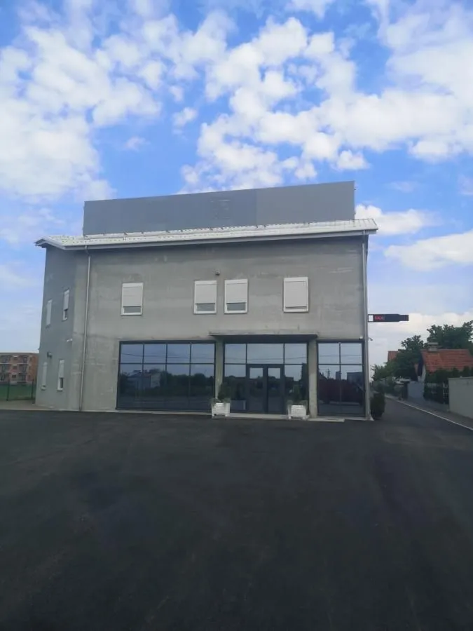 Exterior view of the commercial building with large glass display windows.