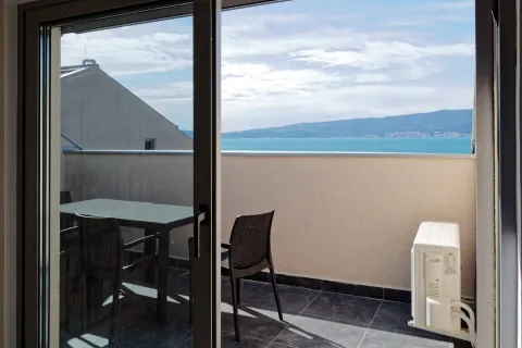 Furnished balcony with seating set and sea view. - image 8