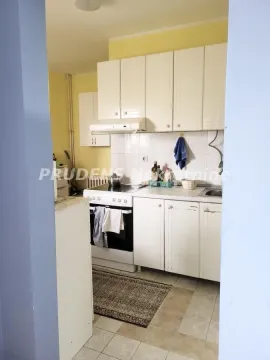 View of the kitchen with white cabinetry and a stove. - image 12