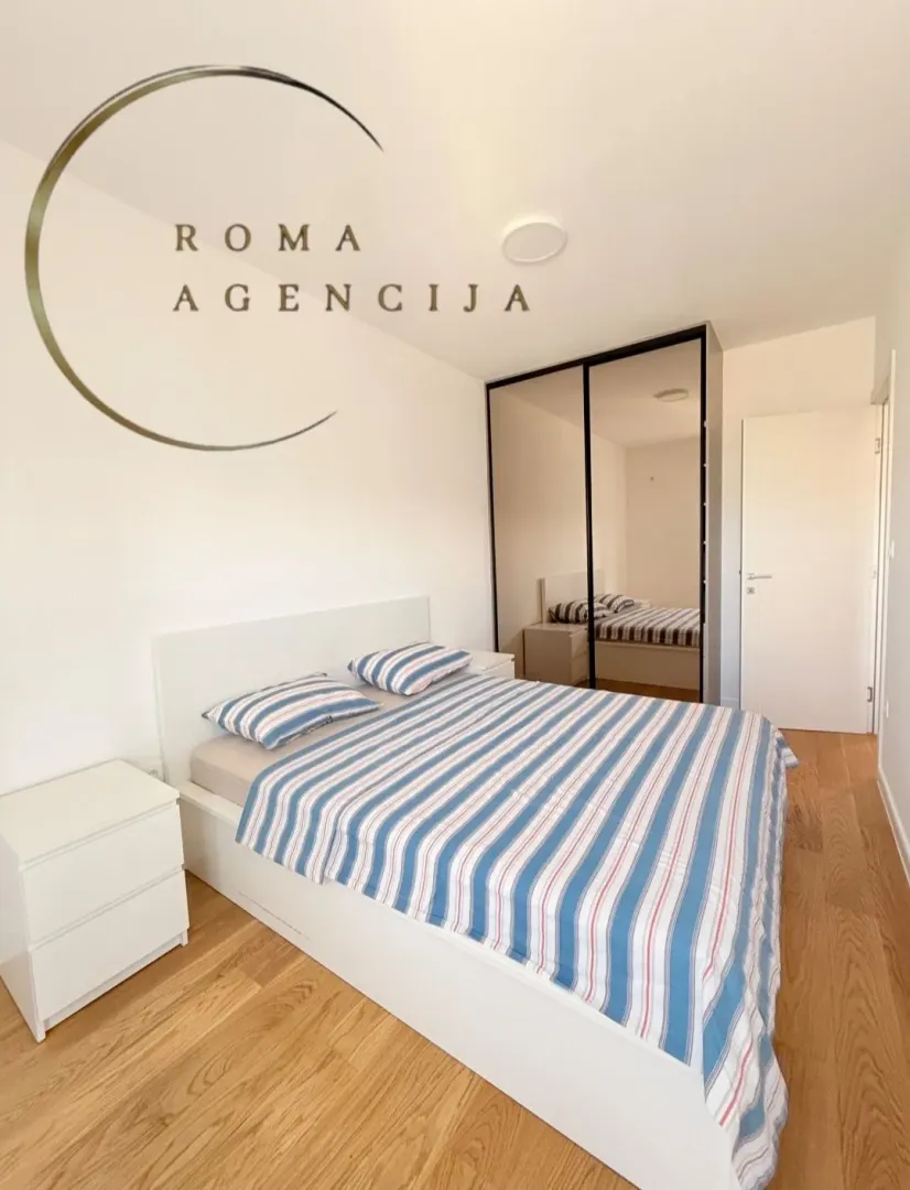Bright and tidy bedroom with a double bed and fitted wardrobe.