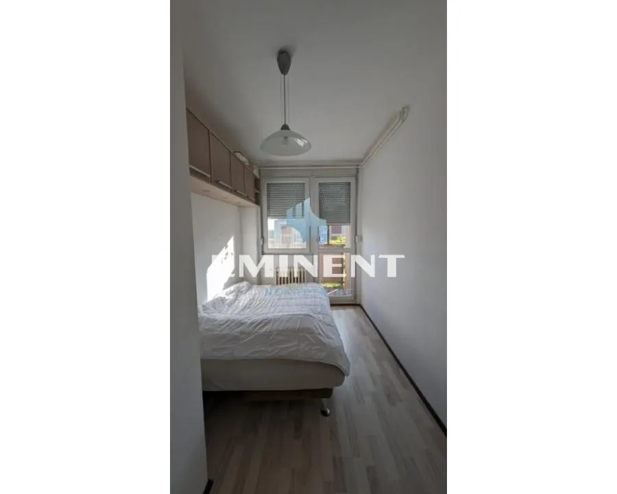 Smaller bedroom with a bed and access to the terrace.