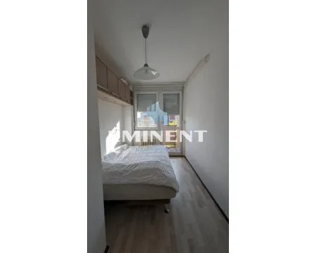 Smaller bedroom with a bed and access to the terrace. - image 6