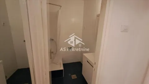 View of the bathroom with a shower enclosure through the doorway. - image 13