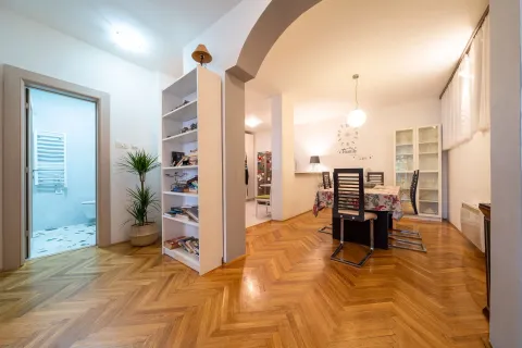 Spacious living room with a dining area and parquet flooring. - image 6