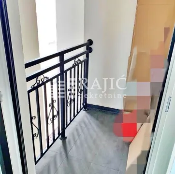 Small covered balcony with metal railing. - image 13