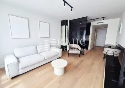 Modern living room with a sofa and dining area. - image 3