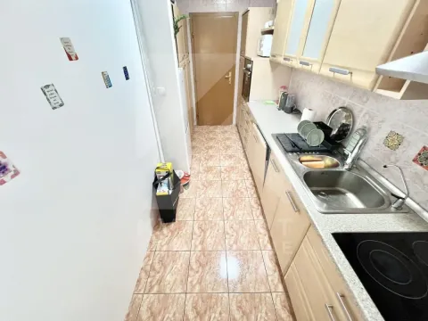 Small kitchen with wooden elements and a sink. - image 6