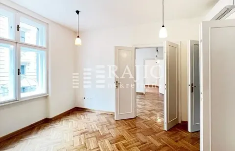 Empty room with parquet flooring and white wooden doors. - image 13