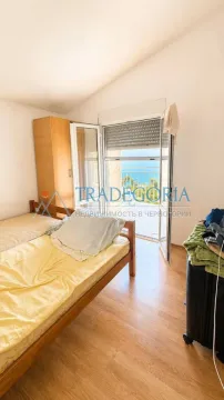Bedroom with a bed and access to a terrace with a sea view. - image 6
