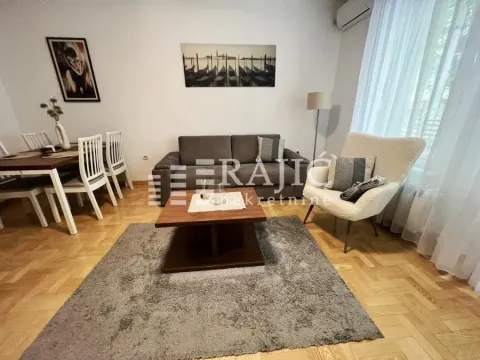 Spacious living room with sofa, armchair and dining area. - image 2
