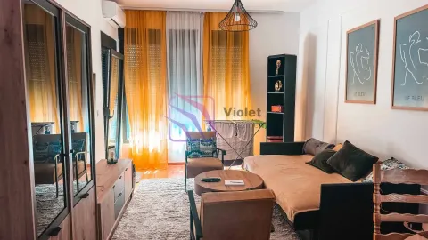 Living room with a sofa, coffee table, and windows with yellow curtains. - image 3