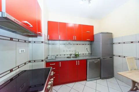 Kitchen with red cabinets, sink and built-in appliances. - image 5